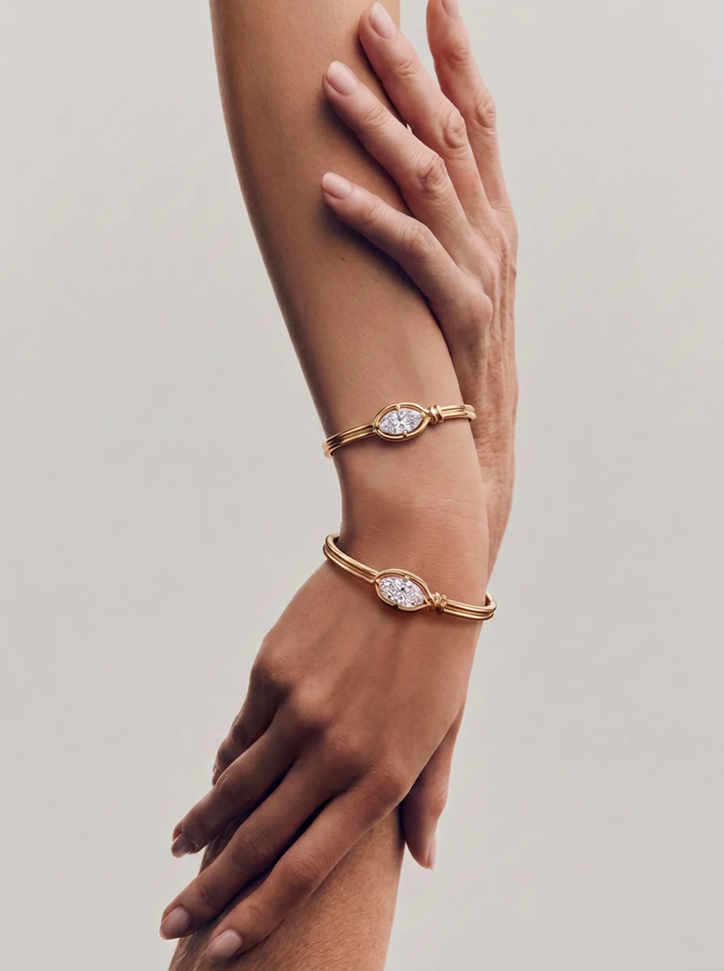Family bracelets worn across two hands of different generations.
