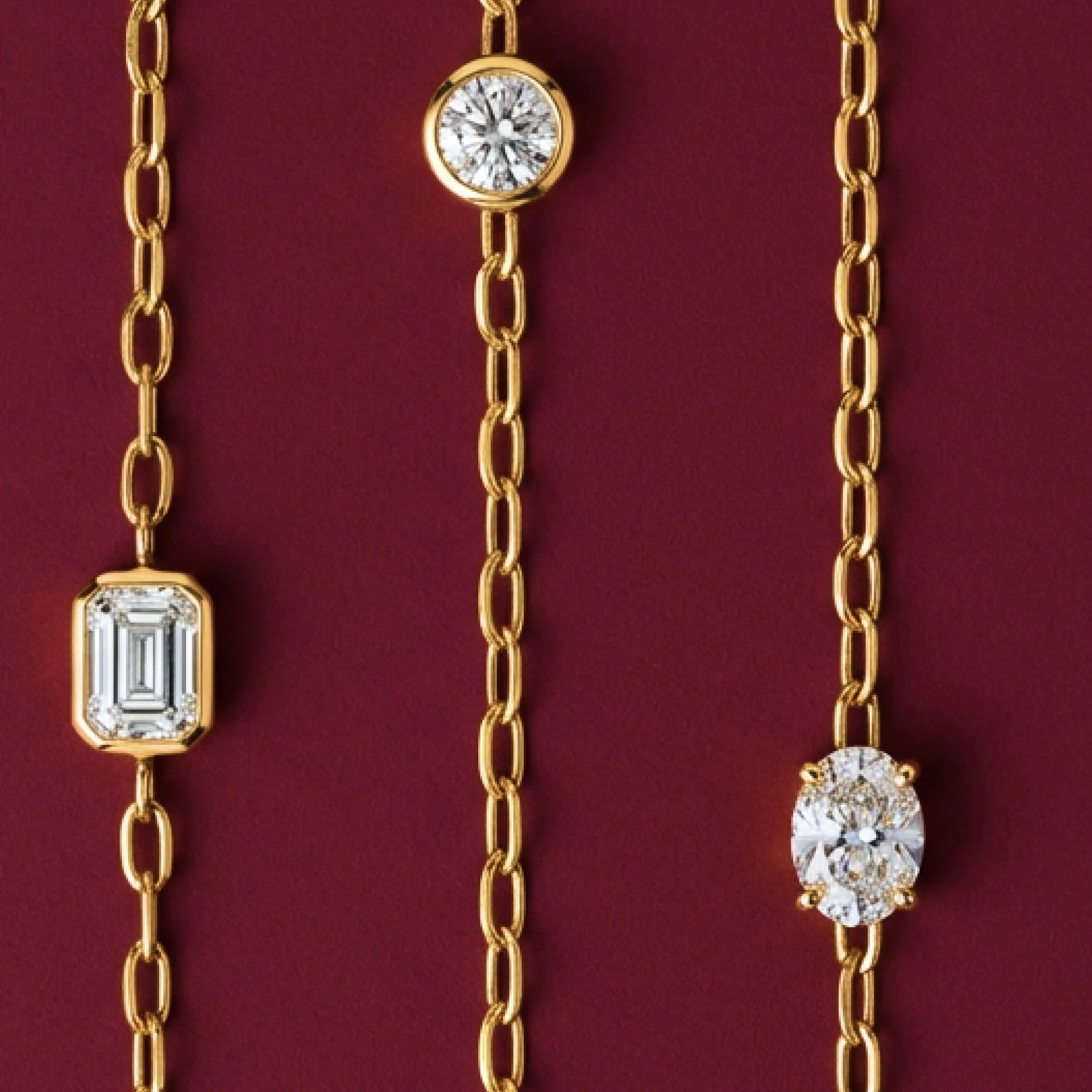 Warm-gold legacy chains set with diamonds on burgundy velvet.