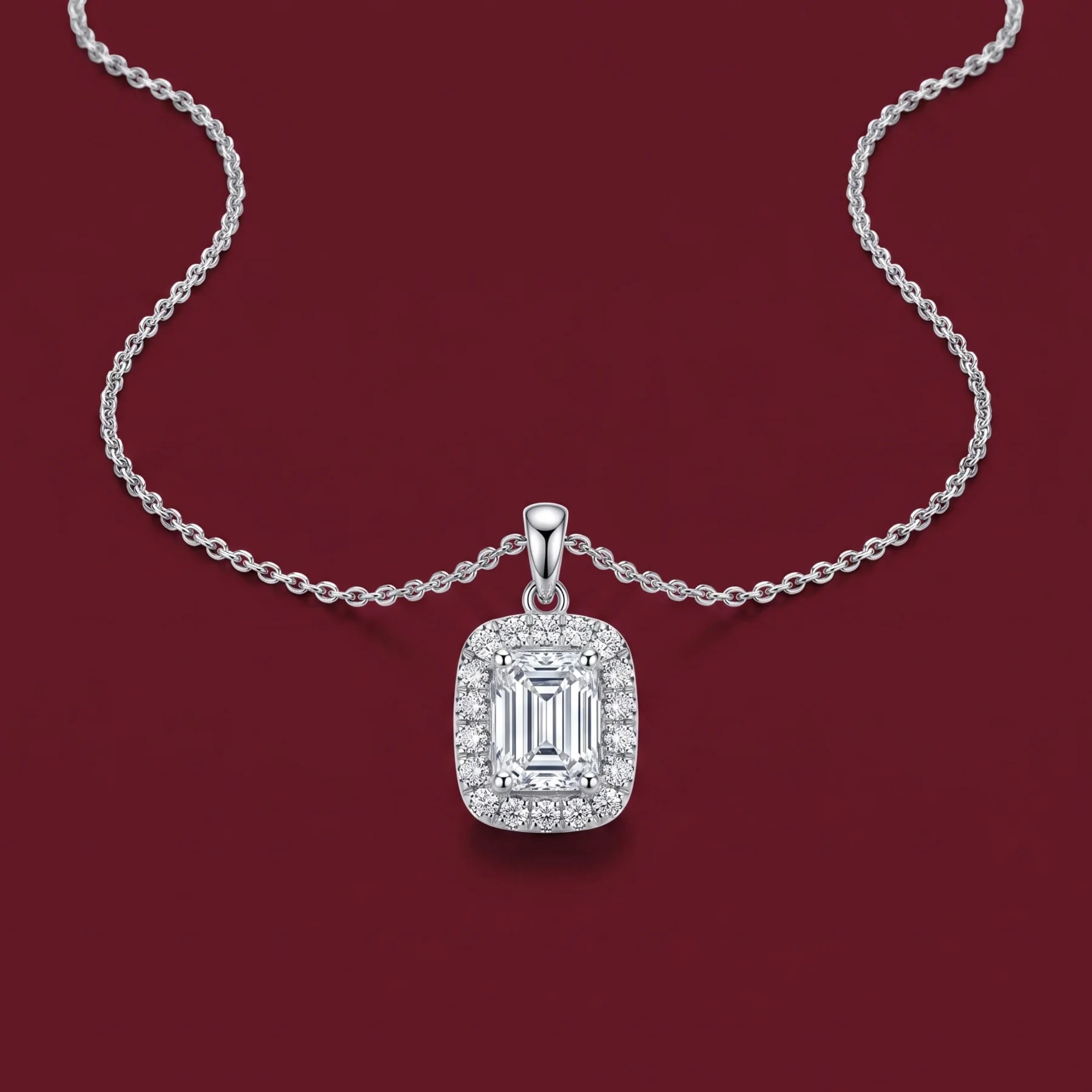 A legacy locket pendant with a diamond on burgundy velvet.