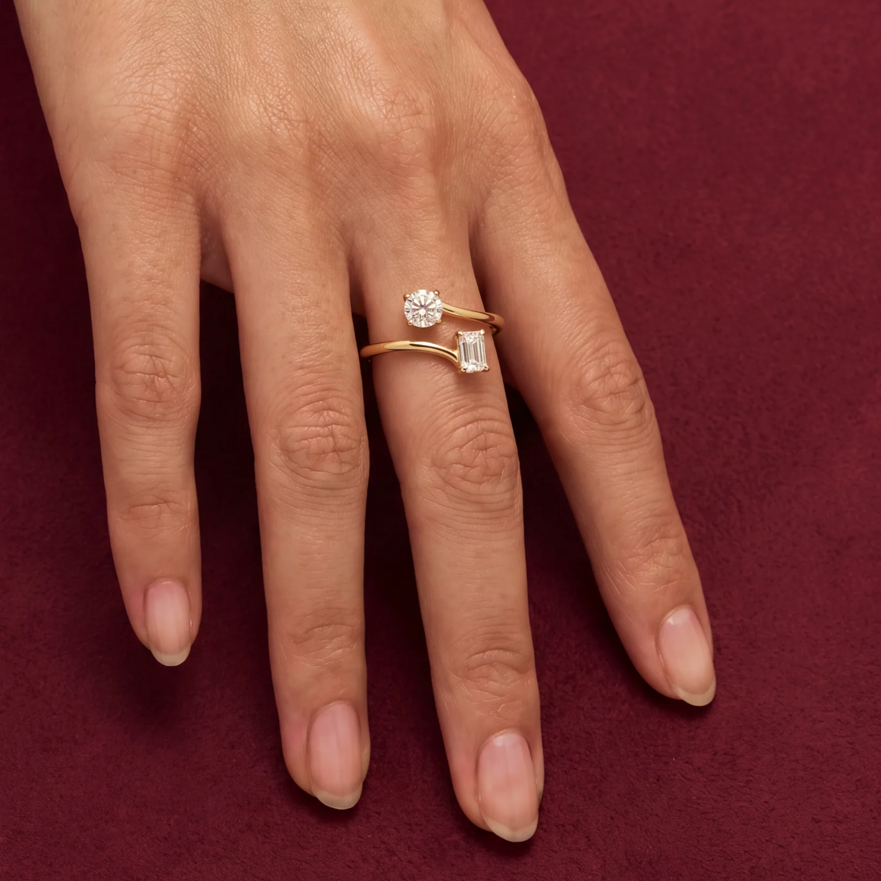 The two-stone love ring worn on a hand.