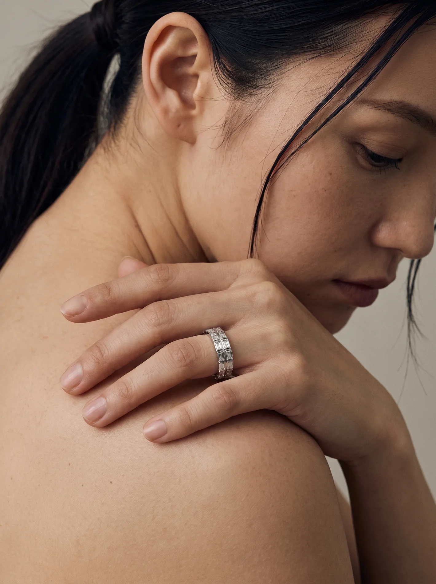 The love diamond band worn on a hand.